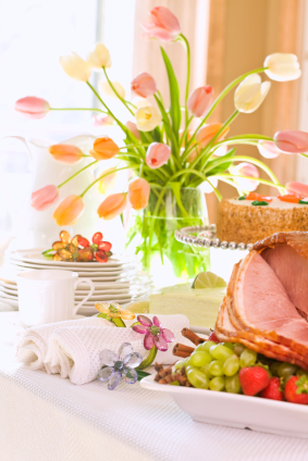 Table set for spring featuring flowers and ham