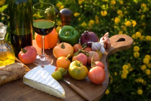 Cutting board with summer ingredients, cheese, and wine