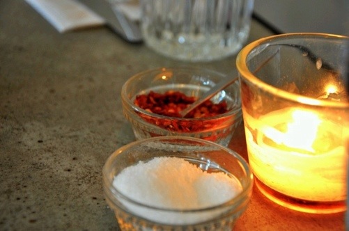 Salt and pepper by candlelight at Delancey pizzeria in Seattle, WA